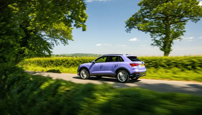 Purple Audi Q3 driving in the English country side on a sunny day