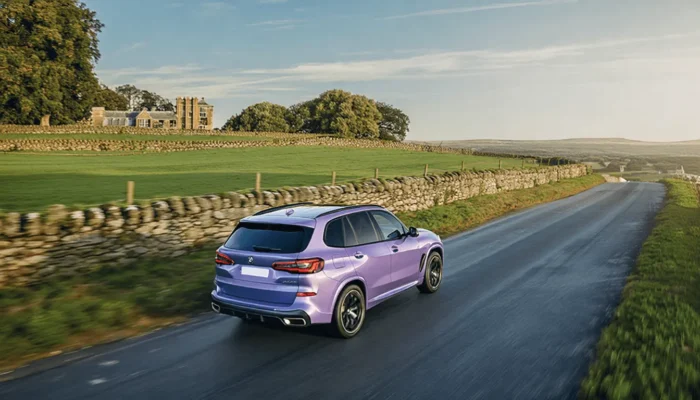 BMW X5 driving on an English road in sunny weahter