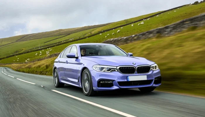 Purple BMW 3 series on an English road