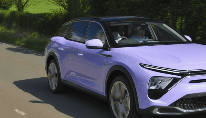 a light purple citroen driving on the road in the uk in the sunshine