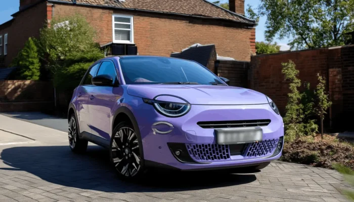 a fiat car parked on the side of the road outside a house in the united kingdom