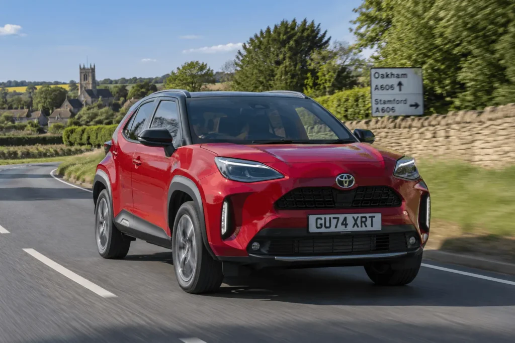 Red toyota driving on the road in the UK